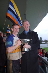 Trevor Phelan accepts the Intermediate Cup from Offaly Chairman Pat Teehan